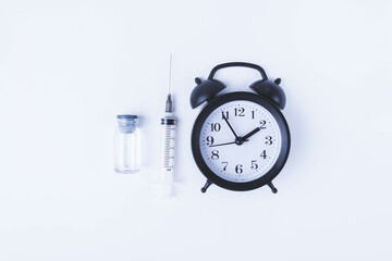 Time for vaccination. Watch and syringe with vaccine. Date and time of preventive vaccinations to...