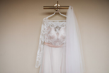 wedding dress hanging on a wall chandelier