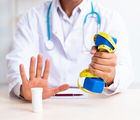 Young male doctor in sport and dieting concept
