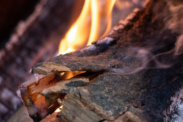 Fire in the fireplace with firewood and coal. Firewood is burning