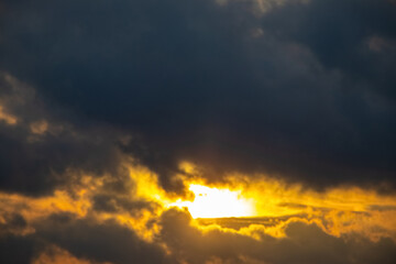 Dark storm clouds illuminated by the bright evening sun, panorama