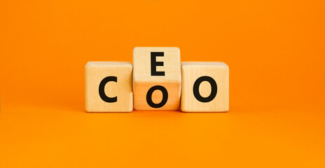 CEO or COO symbol. Concept word CEO chief executive officer or COO chieve operating officer on wooden cubes. Beautiful orange table orange background. Business and CEO or COO concept. Copy space. - obrazy, fototapety, plakaty