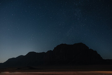 Nightsky over Wadi Rum mountains and desert landscape in Jordan