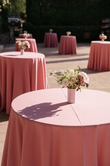 Wedding day.Pink Tables with bouquets