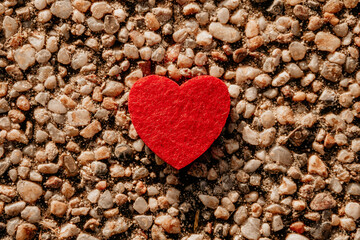 textile valentine heart on pebbles