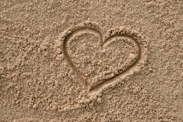 Valentine's heart drawn with a stick on the sand 