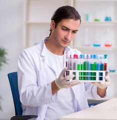 Young male chemist working in the lab