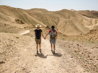 young couple holding hands and hiking