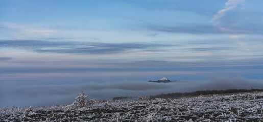 Winter evening panorama from the hills with blue sky, Beshtau mountain peeking out of the clouds,...