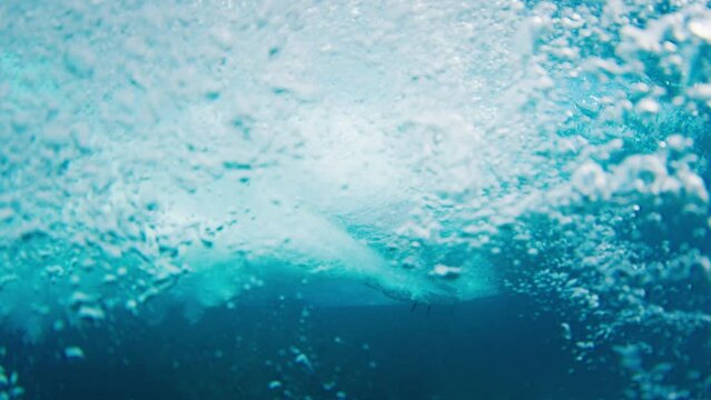 Man surfs ocean wave in the Maldives