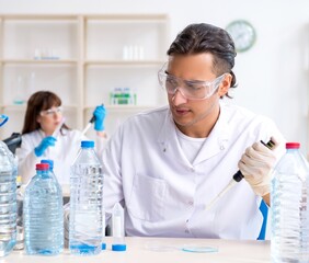 Two chemists working in the lab
