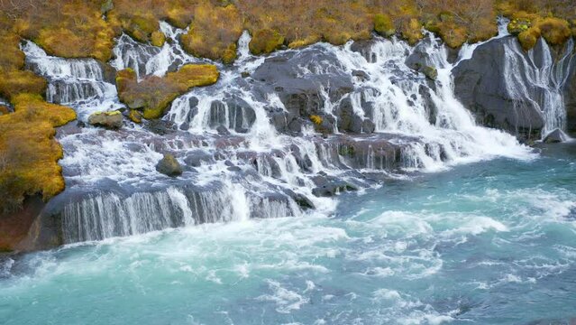 Autumn Waterfall in Iceland. Pure Turquoise Water in Mountain River. Popular Tourist Spot. Famous Travel Destination. Beautiful Nature, Unusual Landscape. Footage Shot in 8K Resolution 4320p