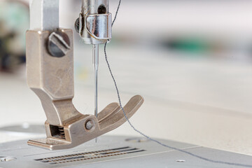 Sewing machine needle with thread and fabric