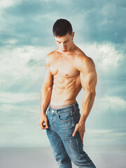 Three quarters shot of handsome shirtless athletic young man