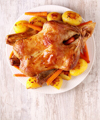 whole duck with potatoes and carrot