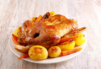whole duck with potatoes and carrot