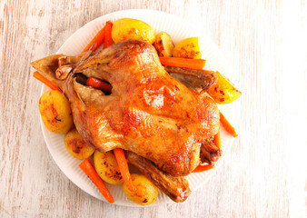 whole duck with potatoes and carrot