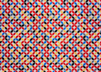 Close up on a fabric depicting a traditional japanese furoshiki fabric printed with a Shippotsunagi pattern depicting endlessly linked colorful circles which is an auspicious symbol of harmony.