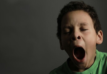 boy yawning with open mouth on black background with people stock image stock photo   - obrazy, fototapety, plakaty