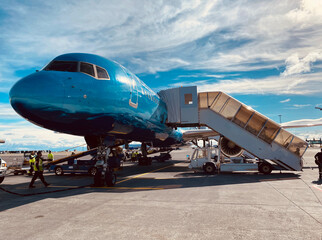 Colorful airplane disembarking passengers on the tarmac at the Reykjavik airport