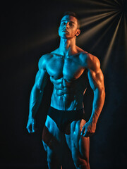 Handsome young male bodybuilder in studio shot