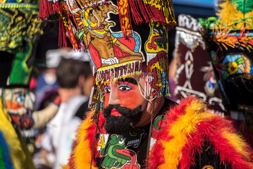 Obraz premium Chinelo or Chinelos are a traditional colorful costumed dancer in carnaval, is popular in the Mexican state of Morelos near Tepoztlan , State of Mexico and Mexico City, Milpa Alta and Xochimilco.