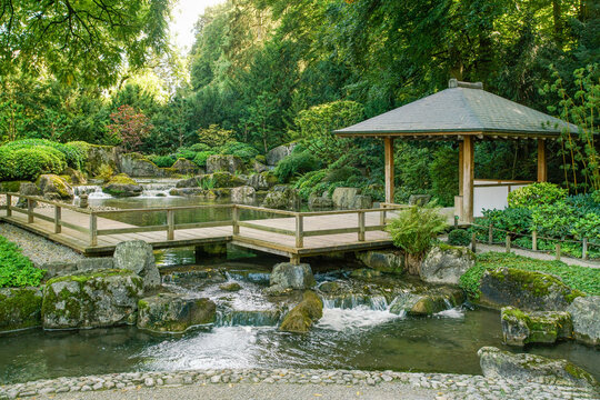 Wooden  gazebo and small waterfall in japanese gardenin Botanical garden  in Augsburg