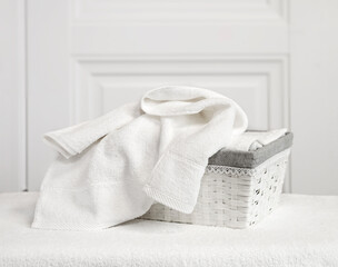 White terry towels in a gray basket