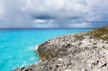 Half Moon Cay Island Rocky Coastline and Rainy Sky