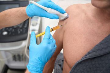 Medical specialist performing biopsy sampling from patient shoulder © Svitlana