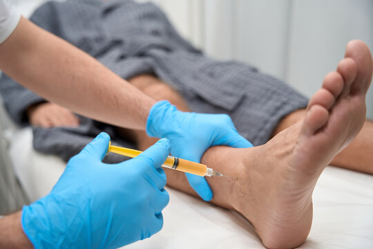 Medical specialist collecting a biopsy sample with a needle
