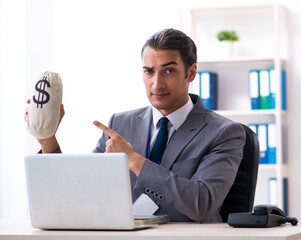Young male accountant working in the office