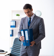 Young male accountant working in the office