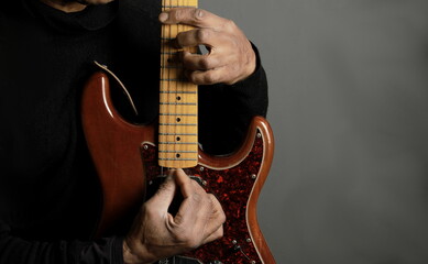 playing electric guitar with grey background with people stock photo  