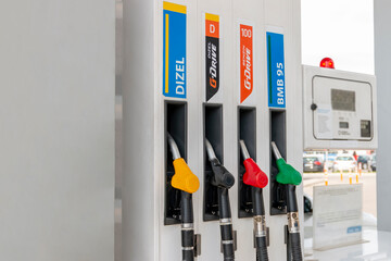 Petrol pump filling nozzles at gas station. Yellow,  black, red, green color fuel gasoline dispenser