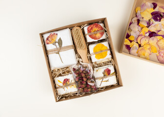 Natural homemade soap wrapped in handmade pressed flower paper lie in a kraft box. Corporate or personal gift idea. Gift for Women's Day, Valentine's Day, Mother's Day.