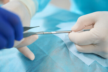 Surgeon holds in his hands tools for installation of bioidentical hormones