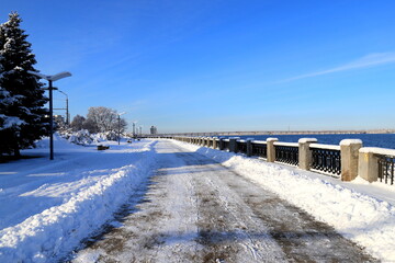 Winter street landscape covered with white snow. Snowy Embankment on frosty day. View of Dnipro, Ukraine