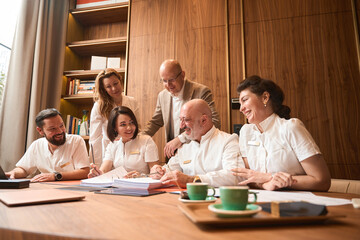 Clinic staff gathered in office of head physician for meeting