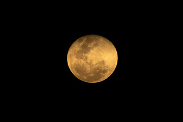 A full moon in a dark sky. yellow moon. Nature.