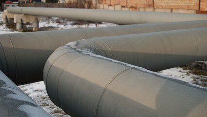 the pipeline, in the photo, is a winding gray pipeline in close-up, the photo was taken in winter