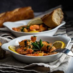 Shrimp scampi served with a crusty baguette