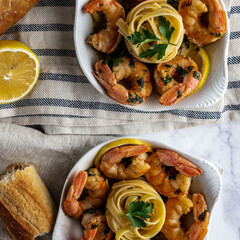 Shrimp scampi served with fettuccini pasta and a crusty baguette