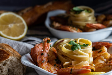 Shrimp scampi served with fettuccini pasta and a crusty baguette