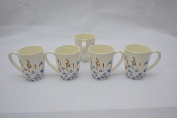 Colorful set of White Ceramic Tea or Coffee mug with Blue red flowers and butterflies on it , isolated on white background