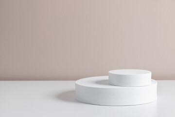 White round pedestal podium mockup on beige background. Front view. Place for text, copy space, mockup