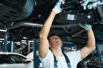 Portrait of worker replacing car parts in tire shop