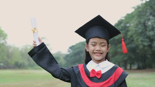 Educational concept of 4k Resolution. Asian girl confidently holding diploma on graduation day.