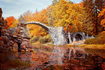 Stone arch bridge Kromlau in autumn, Saxony, Germany, called Rakotz Bridge or devils bridge