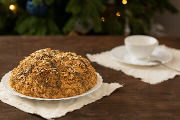 ant hill cake decorated with poppy seeds on a white plate. the concept of a festive tea party